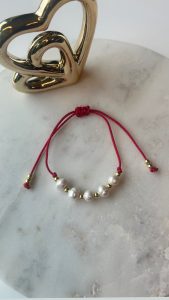 Four pearls with red cord bracelet
